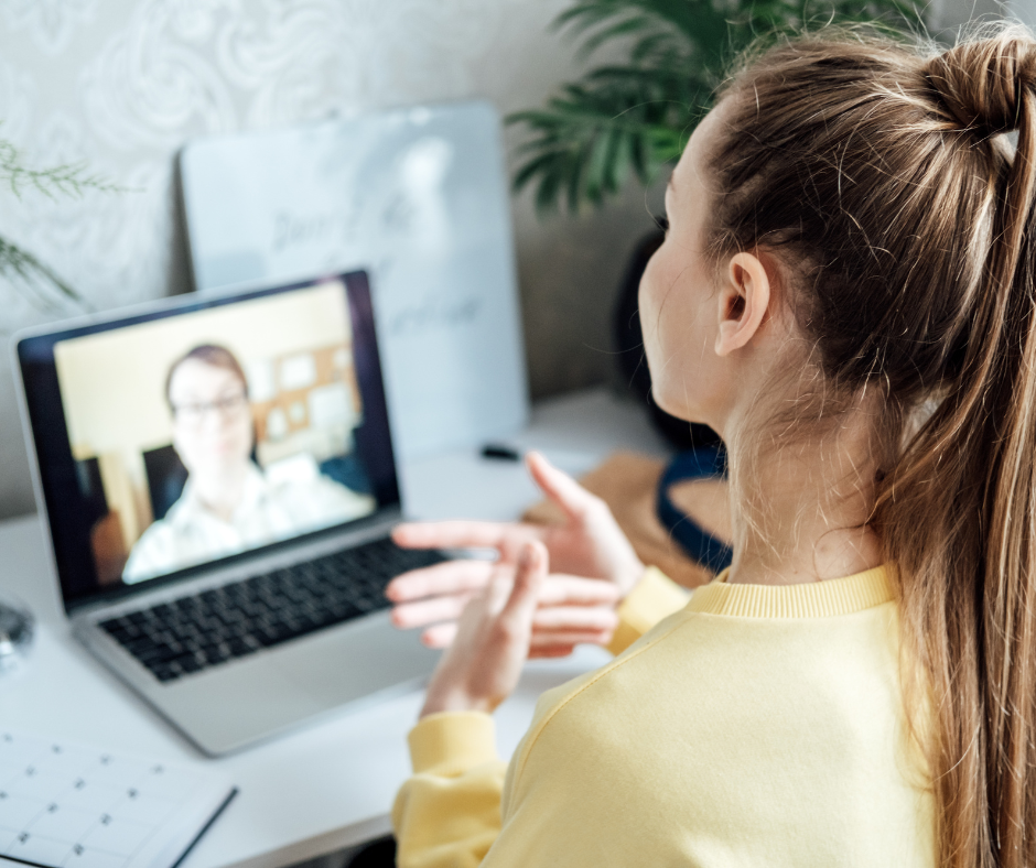 Woman participating in virtual meeting from home workspace, reflecting modern approaches to how to lead a remote team.